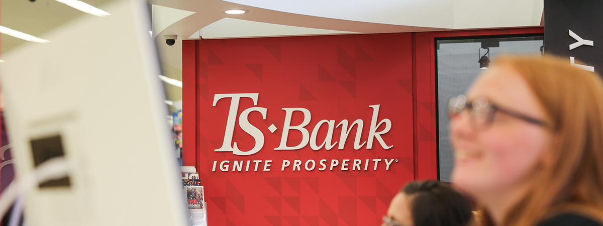 Image of TS Bank logo on red wall at HyVee Branch