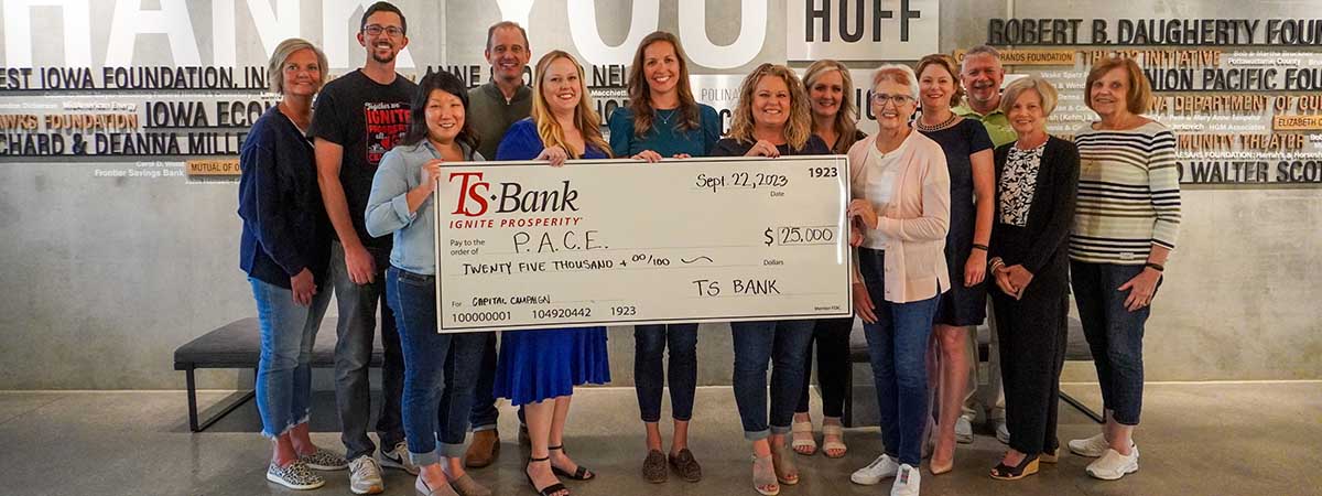 TS Bank employees gifting check to PACE