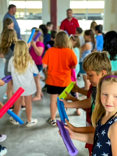 students holding a race track