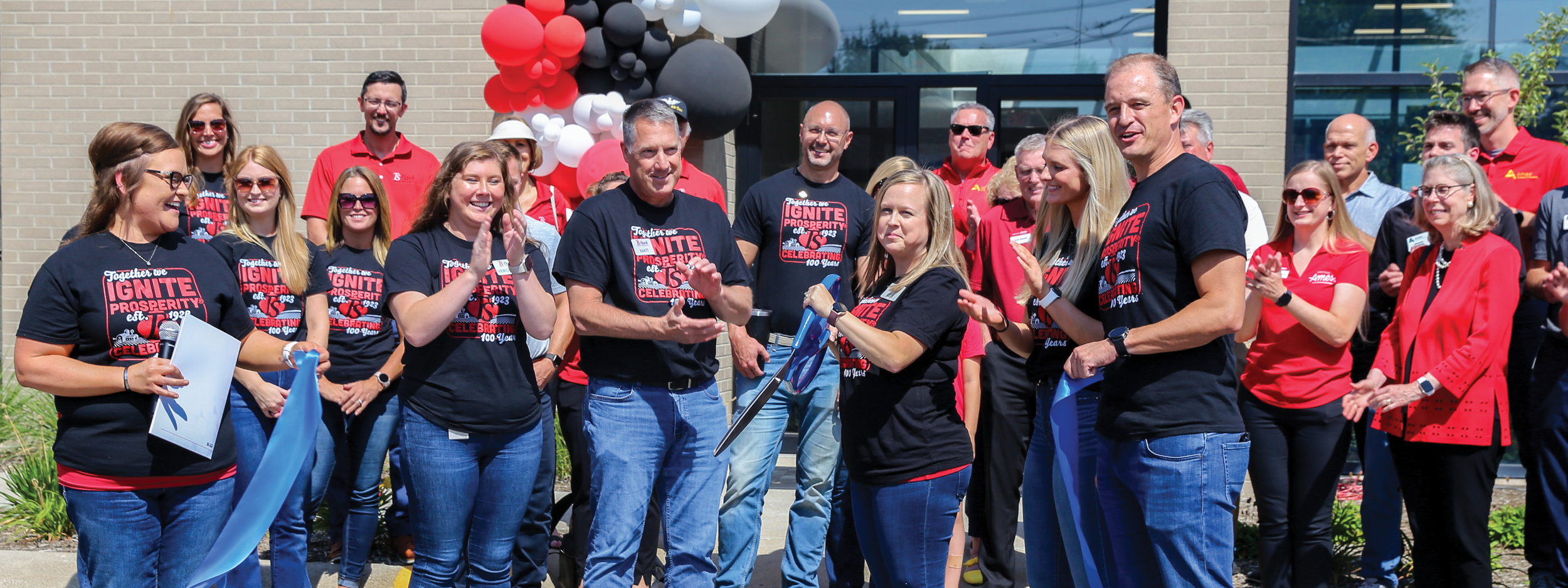 TS Bank employees cut ribbon for Ames Grand Opening