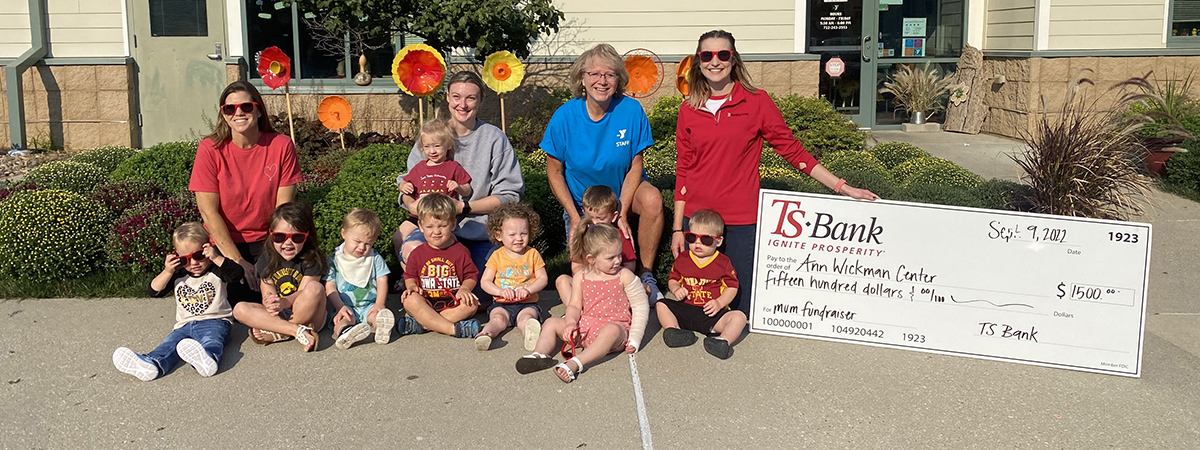 TS Bank employees pose with Ann Wickman staff and child