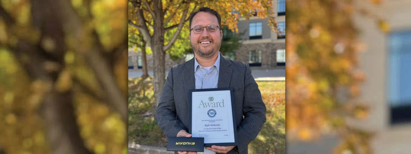 Kyle Osborne holding an award