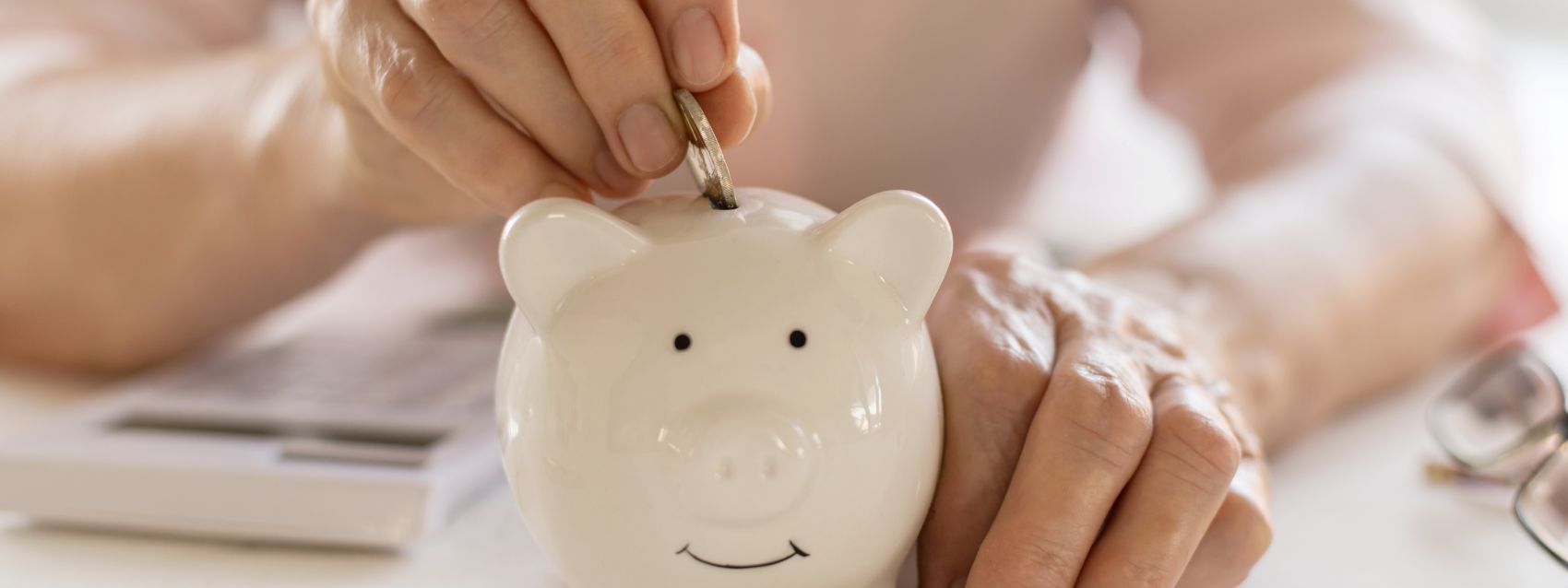 putting coins in a piggy bank