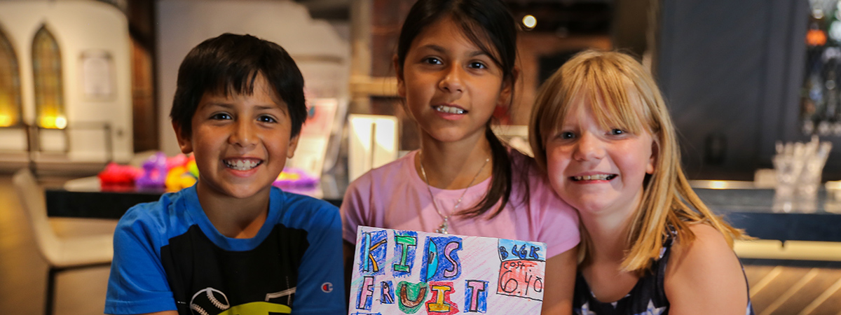 kids holding poster of their business name