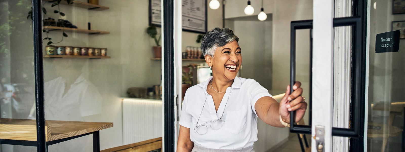 woman holding a door open