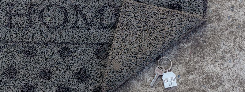 Door mat with key underneath