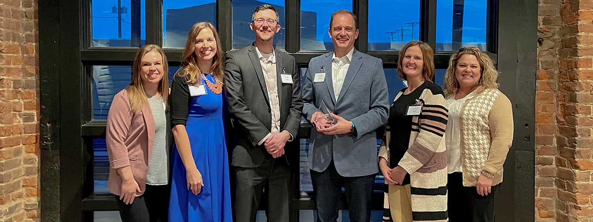 TS Bank employees pose with award