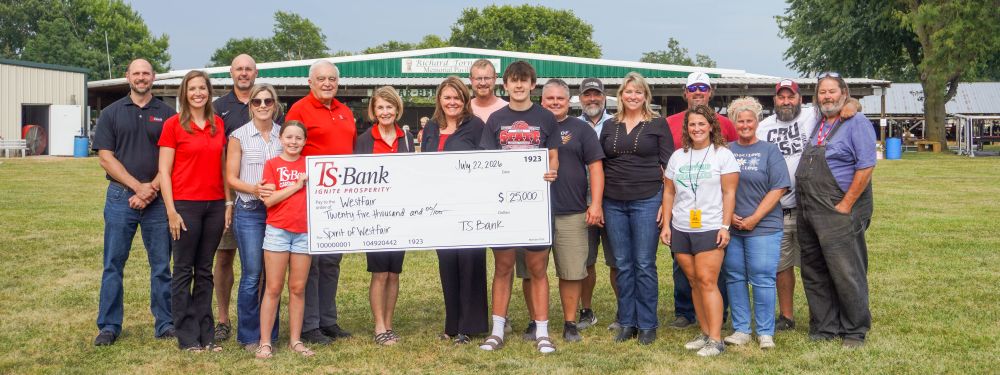 TS Bank employees gifting check to Westfair employees