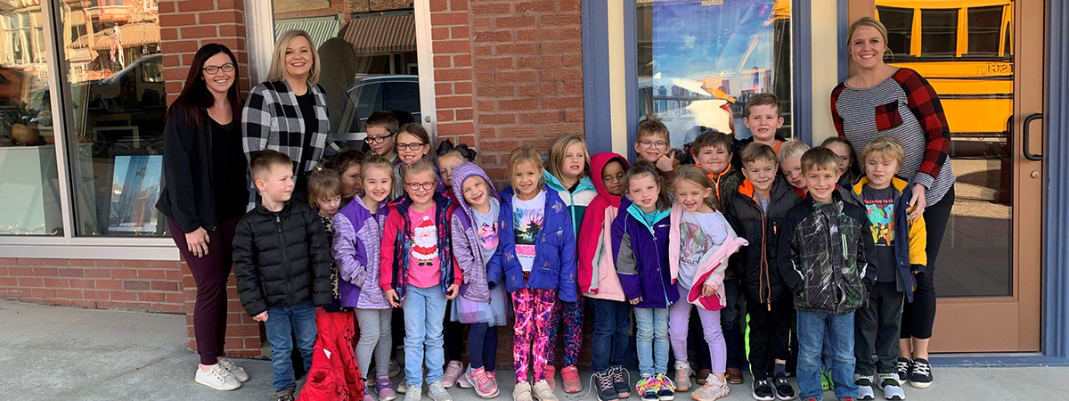 ts bank employees pose with kids at movie theater