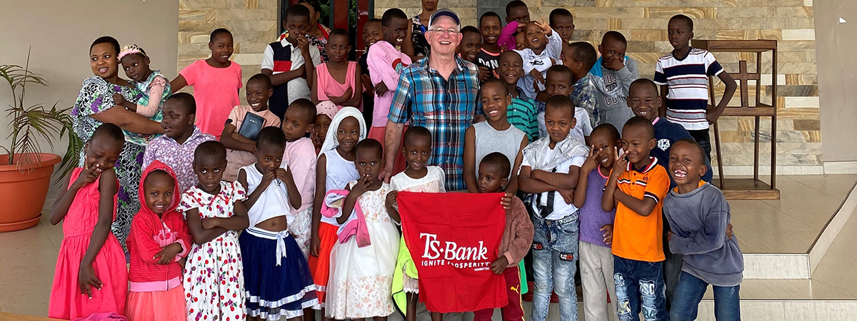 Kim Gibson pictured with the TS Bank flag at the chapel