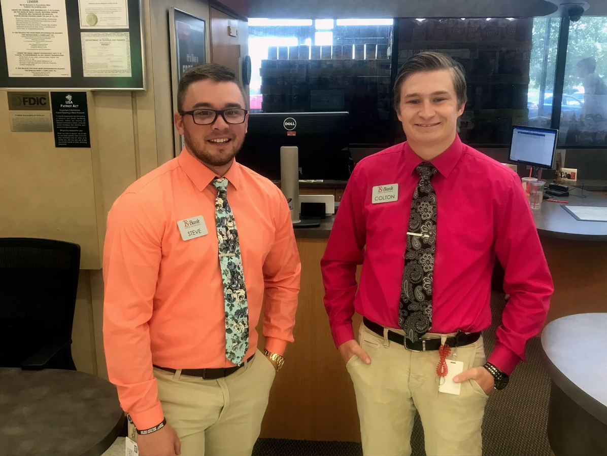 ts bank employees smiling at camera