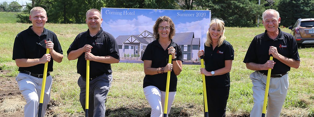 ts bank employees dig the in dirt in front of where the