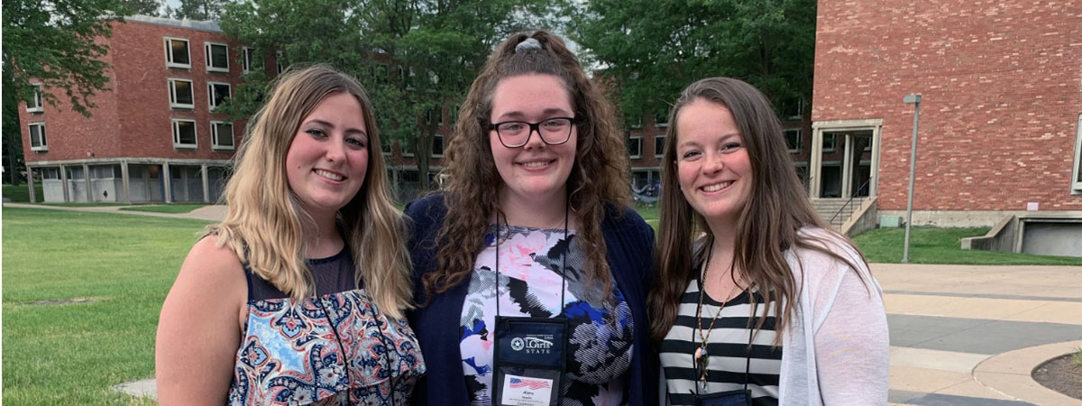 three students that attended girls state pose outside