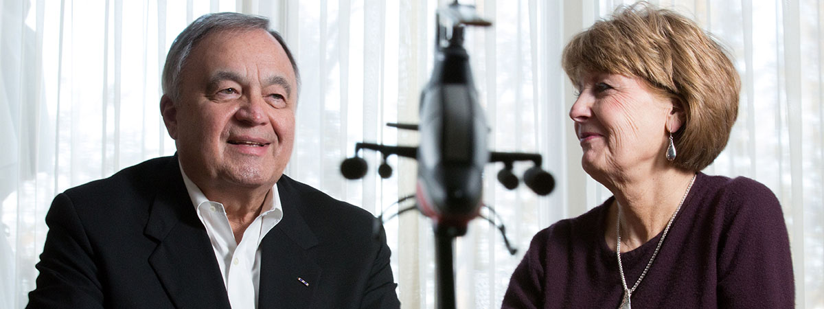 mick and judy guttau smiling as they talk to a journali