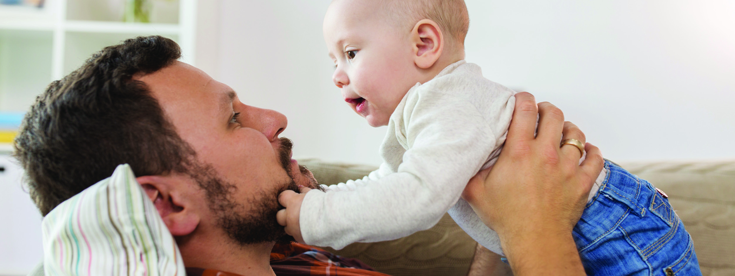 a father and new baby playing together