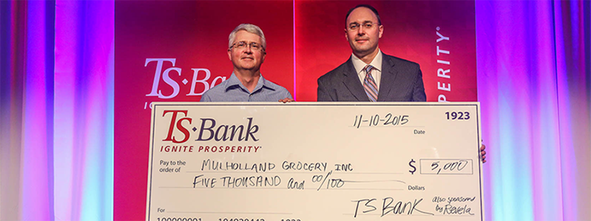 ts bank's josh guttau presents check for $5,000 to mulh