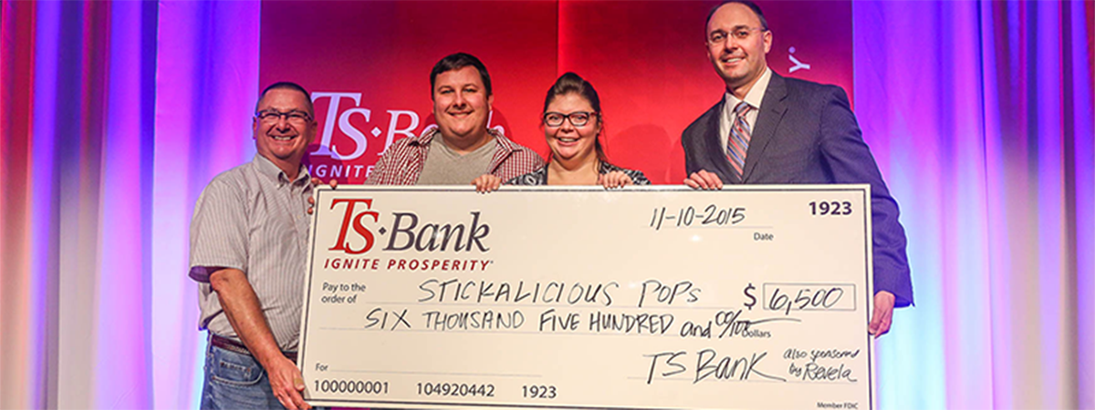 ts bank's josh guttua presents check for $6500 to stick