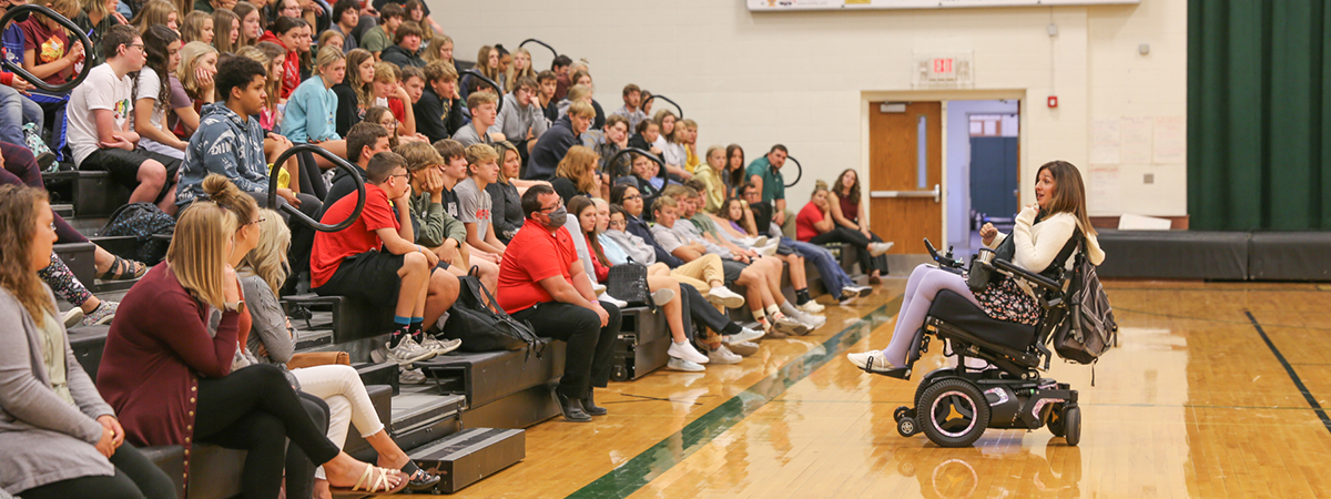 tasha schuh speaks to gym full of students in iowa