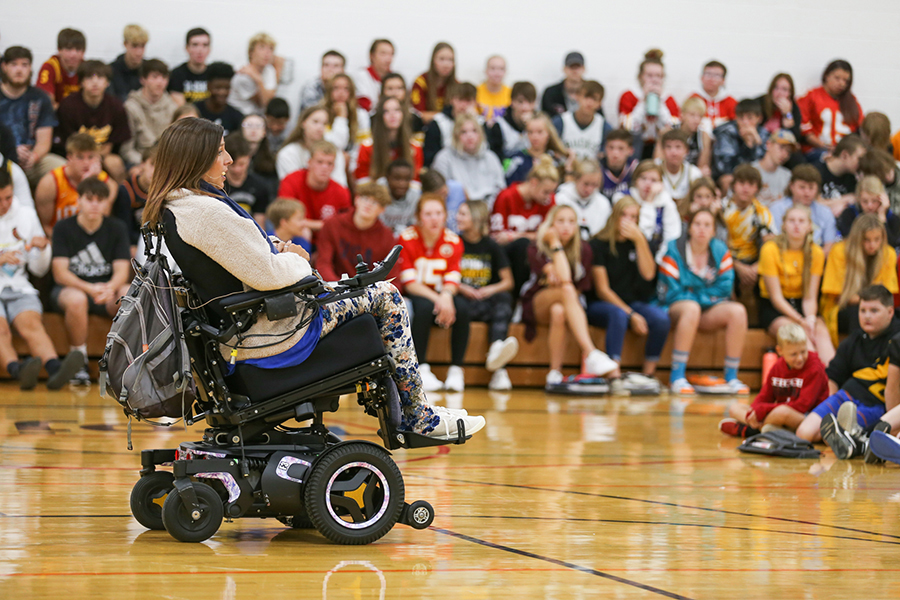 tasha schuh speaking to gym full of students