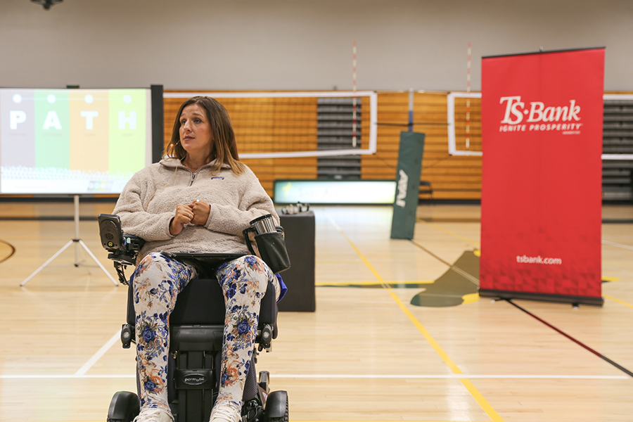 tasha schuh speaking to gym full of students