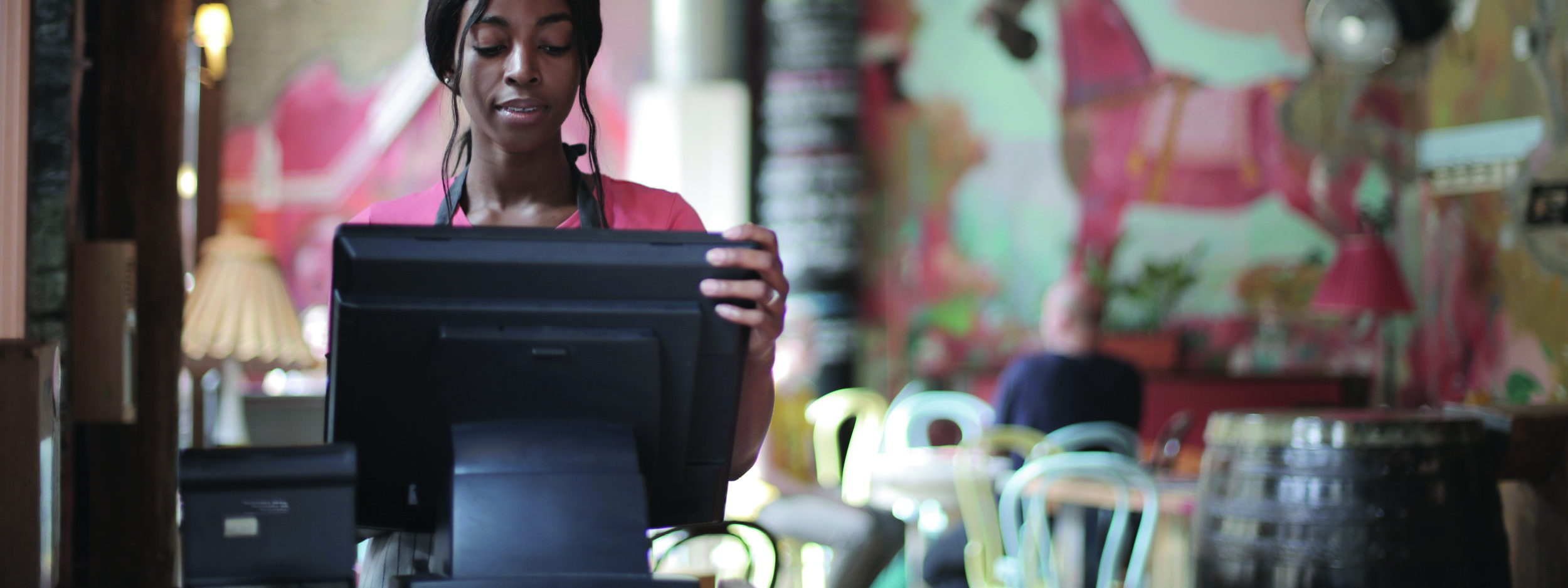 a restaurant employee working on a computer