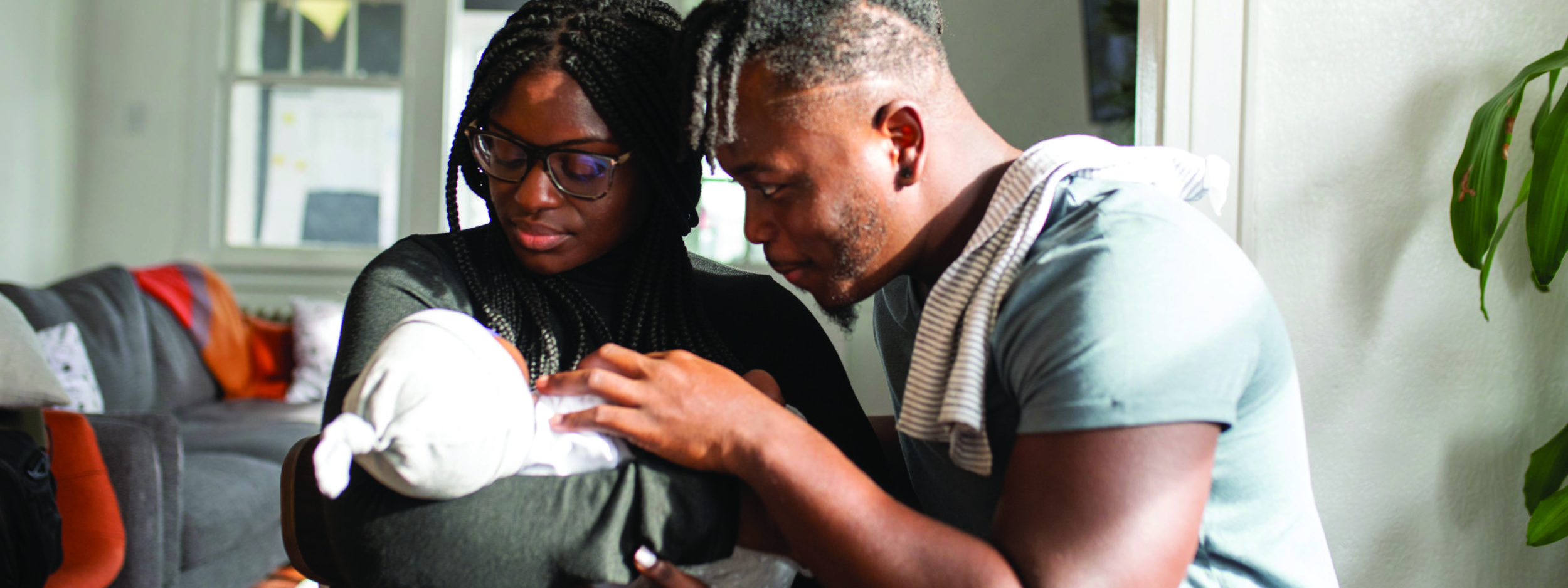 new parents looking at their new baby