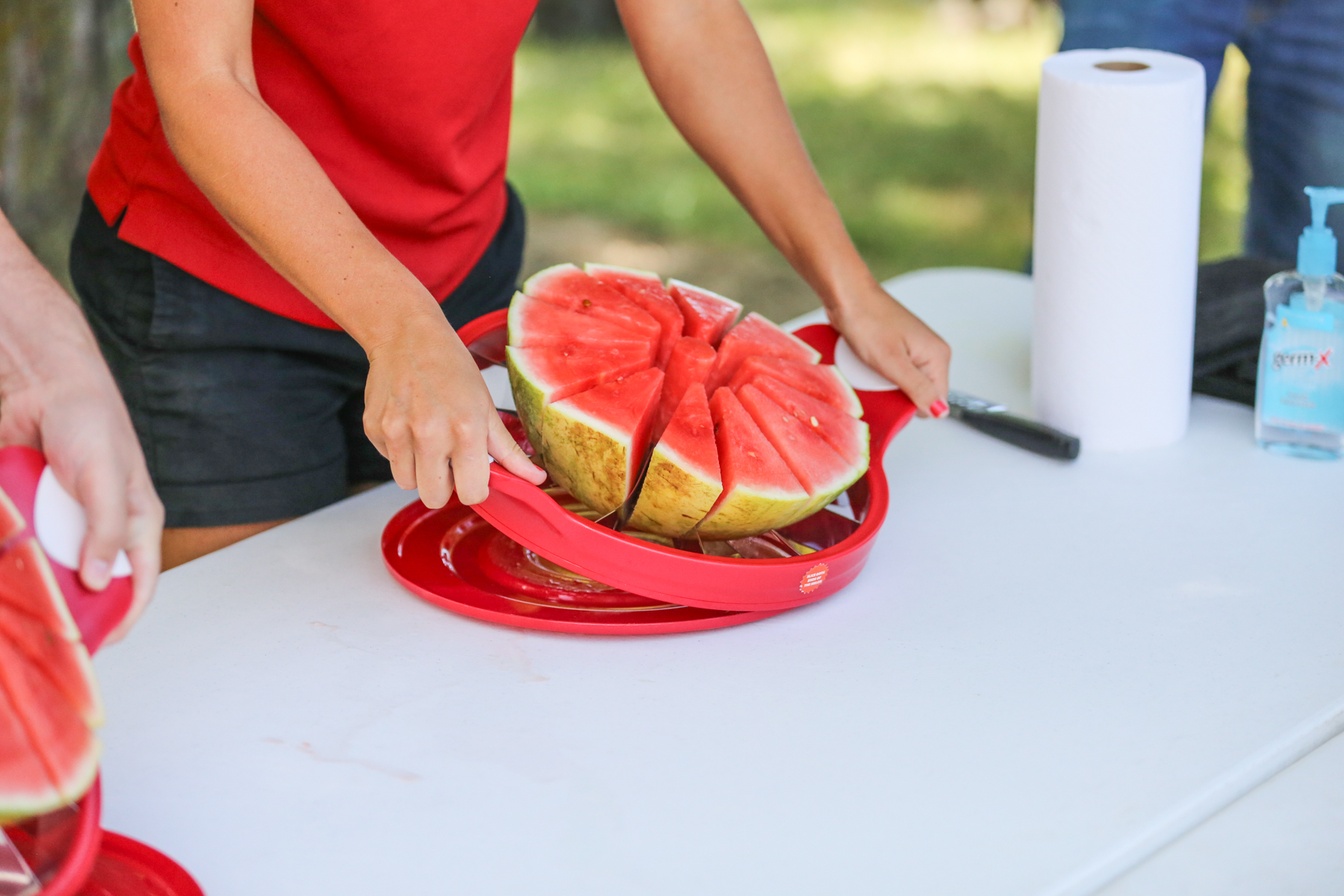 someone using a watermelon slicer