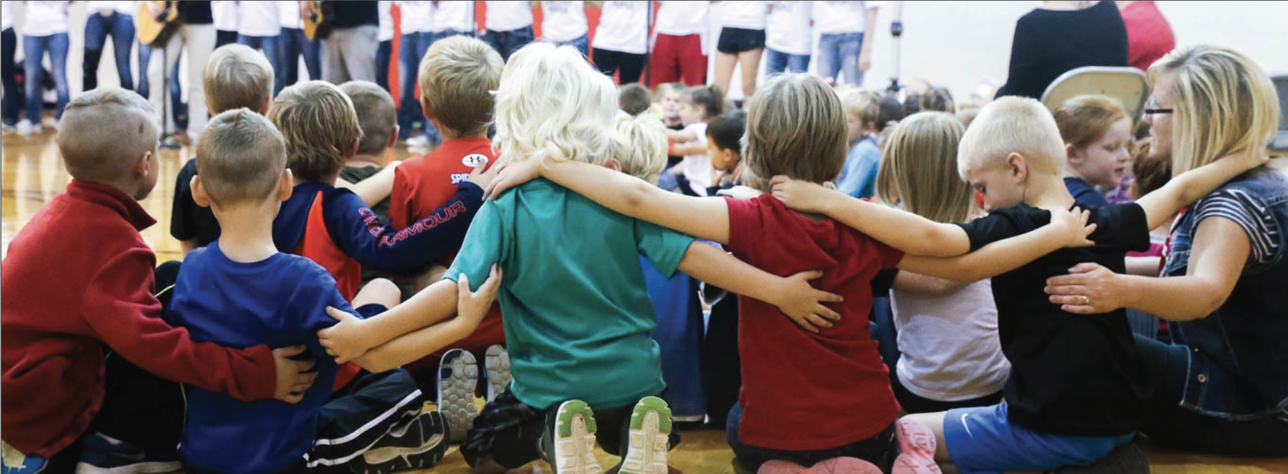 children huddled with arms around one another
